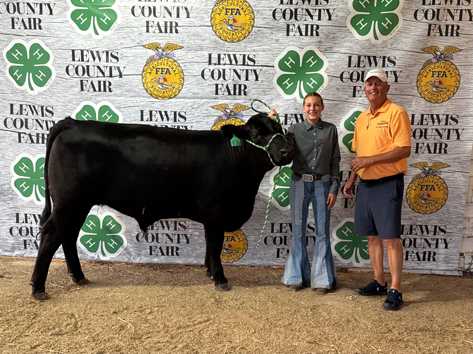 Greg Sharpe with a young 4-H exhibitor and her grand champion steer at the Lewis County Fair