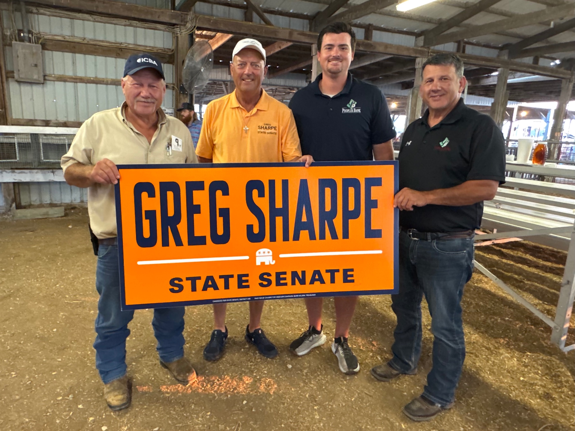 Greg Sharpe with local supporters holding a Greg Sharpe for State Senate yard sign at a Northeast Missouri county fair