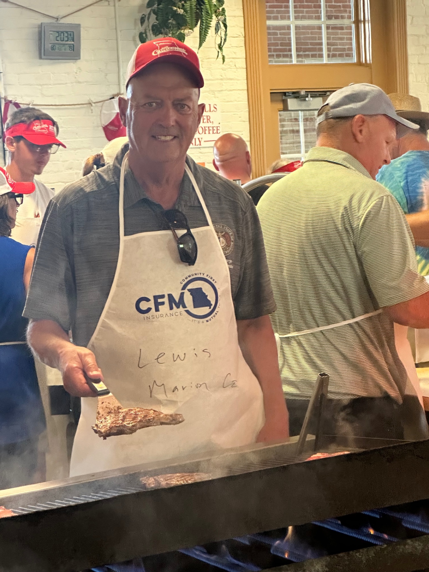 Greg Sharpe grilling steaks at the Lewis-Marion County CFM Insurance community steak fry